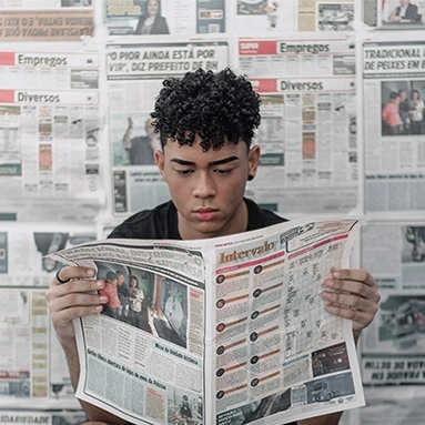Another person holding a newspaper, illustrating media exposure.